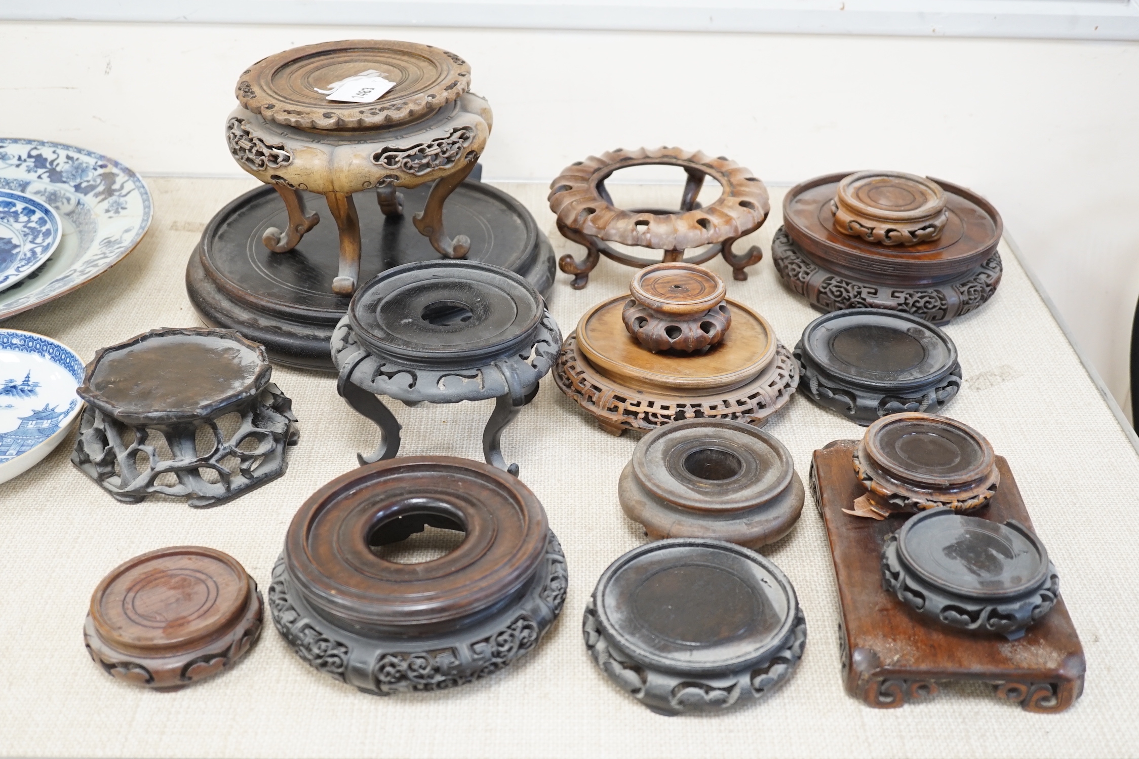 Seventeen Chinese carved wood stands of varying sizes, largest 30cm diameter